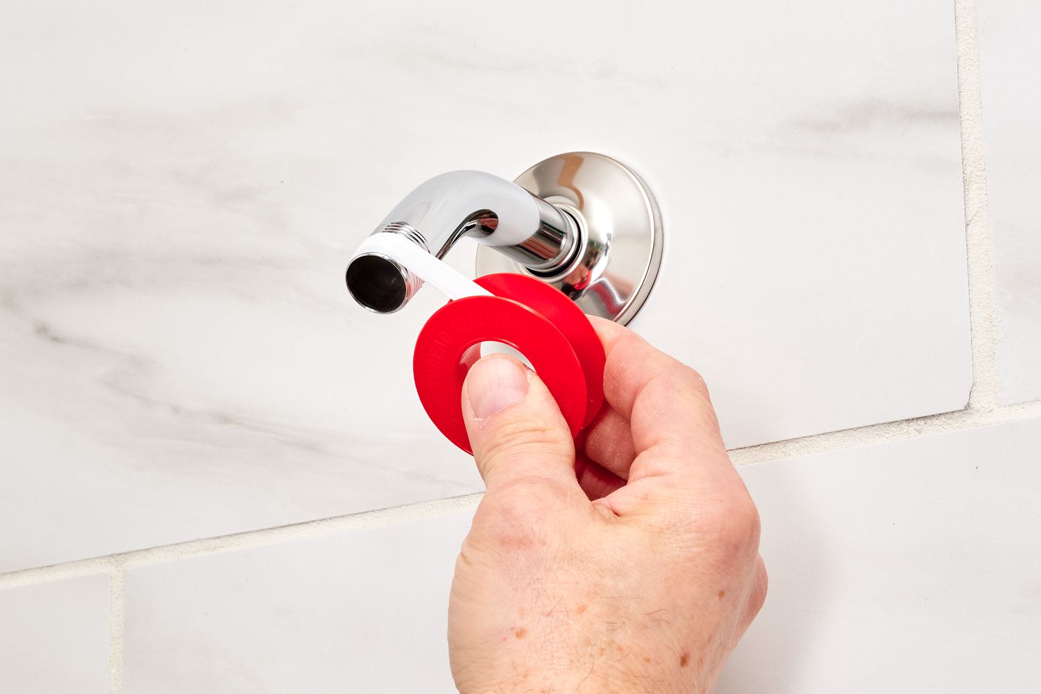 Teflon tape wrapped around shower head pipe