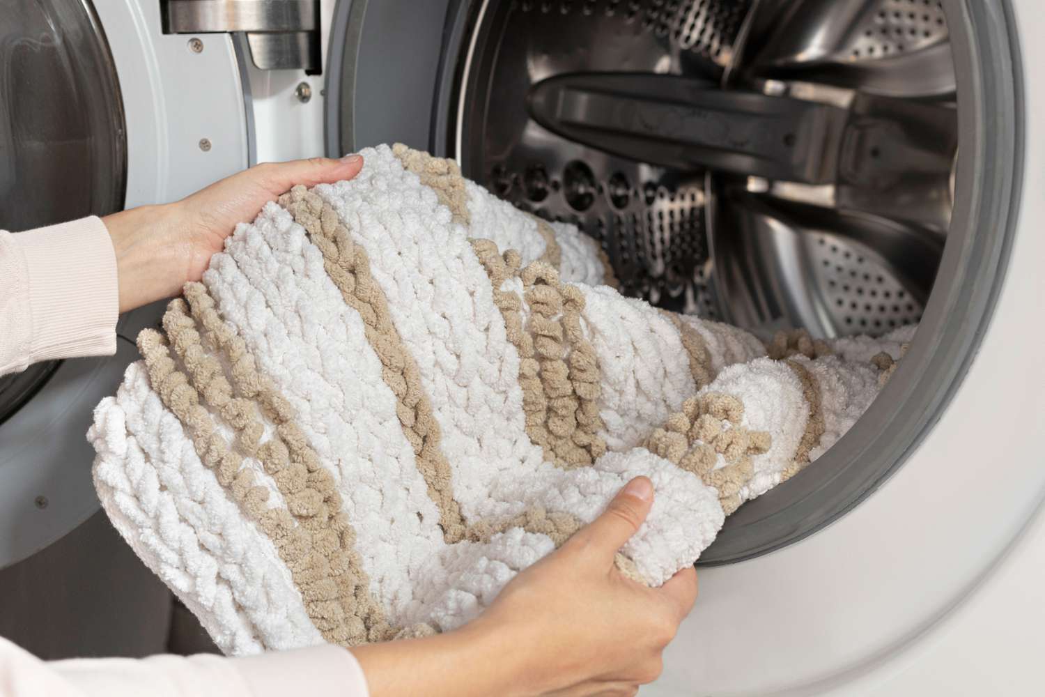 Person cleaning a throw rug in the washer