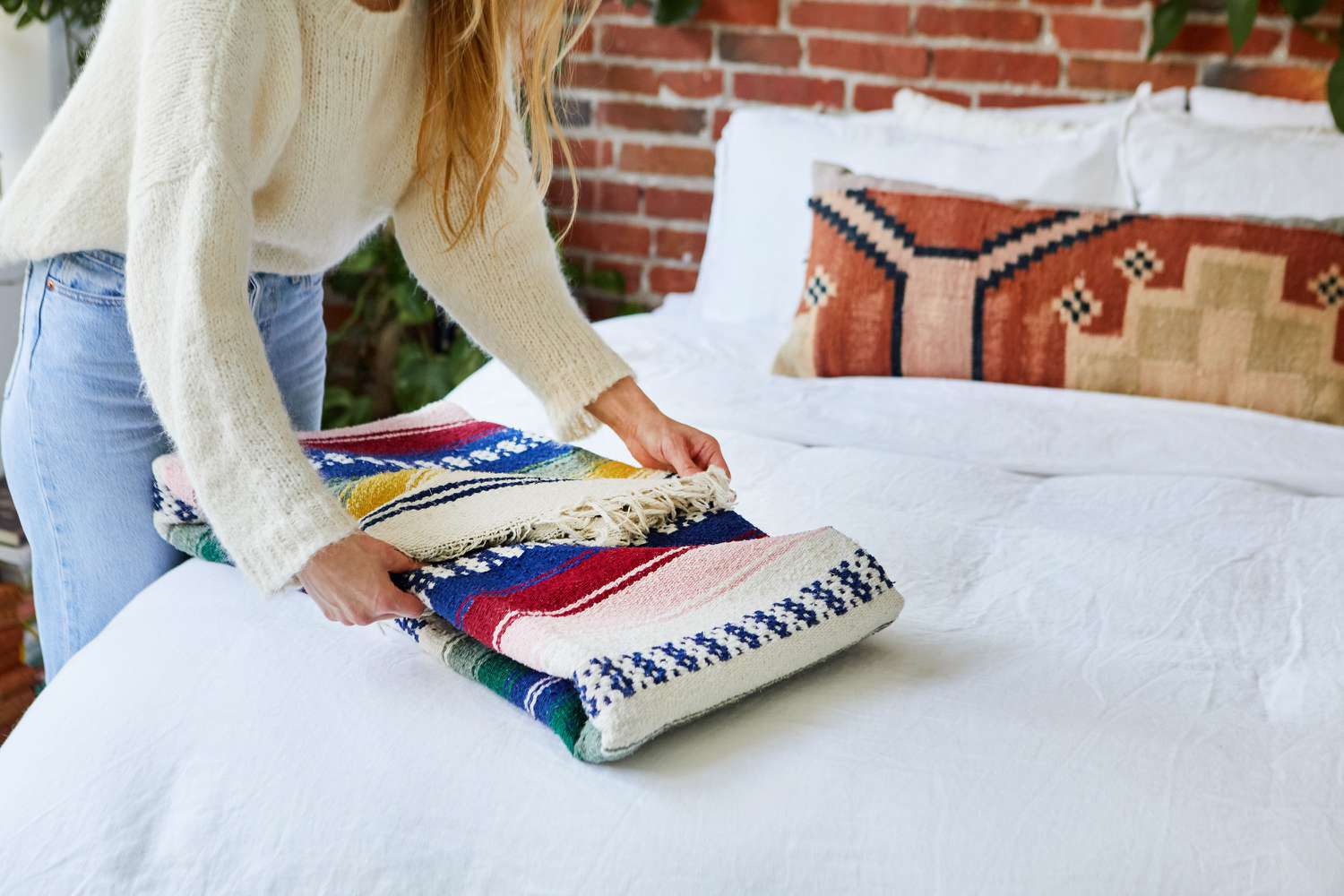 Bulky patterned blanket folded as long rectangle on bed