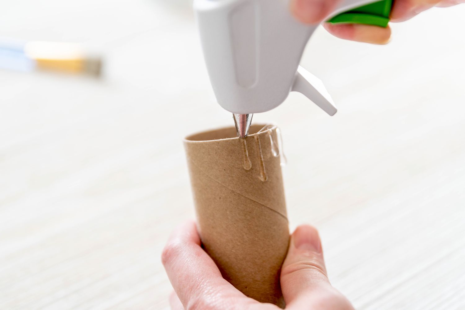 Hot glue drips poured on edges of toilet paper roll