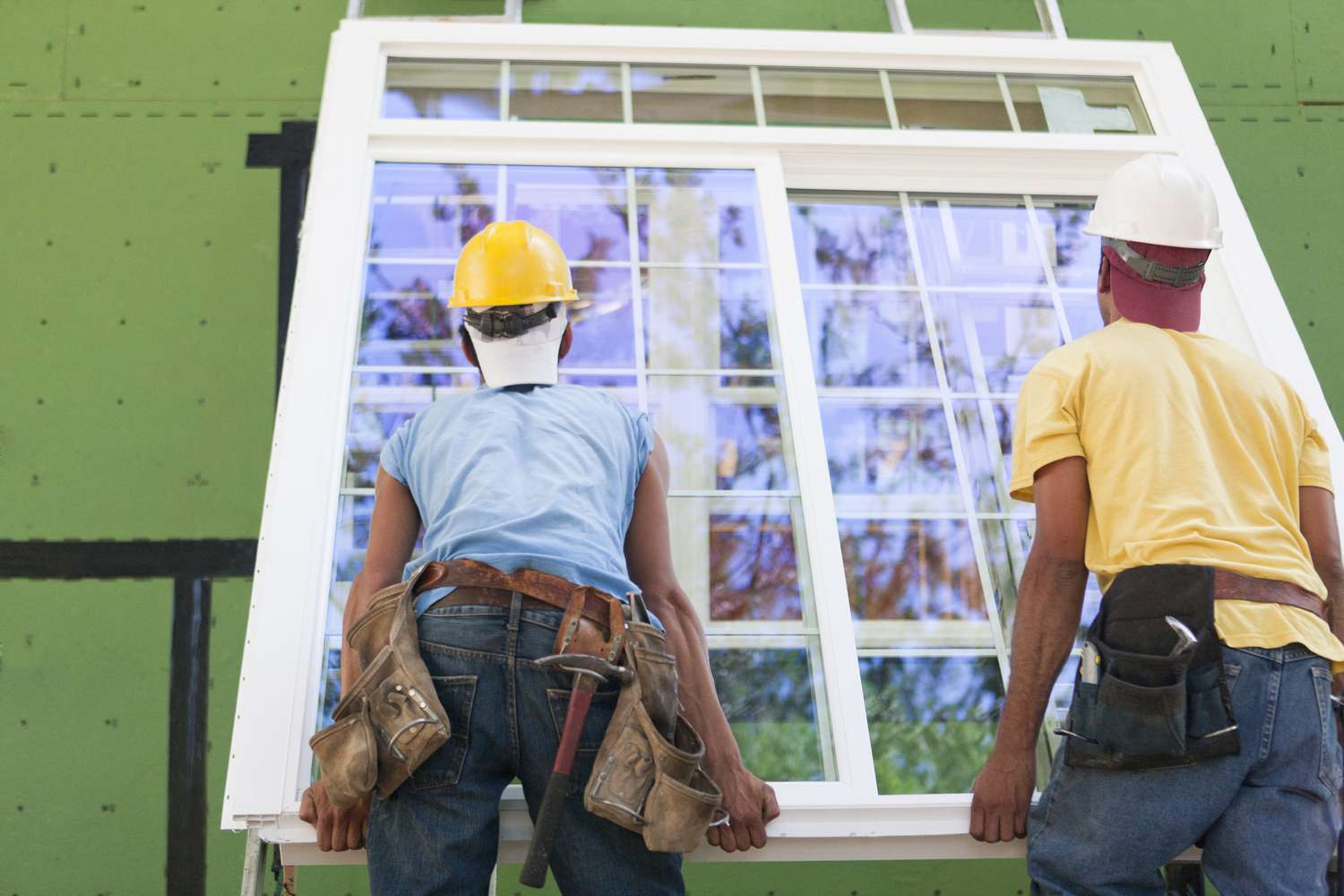 Carpenters installing window