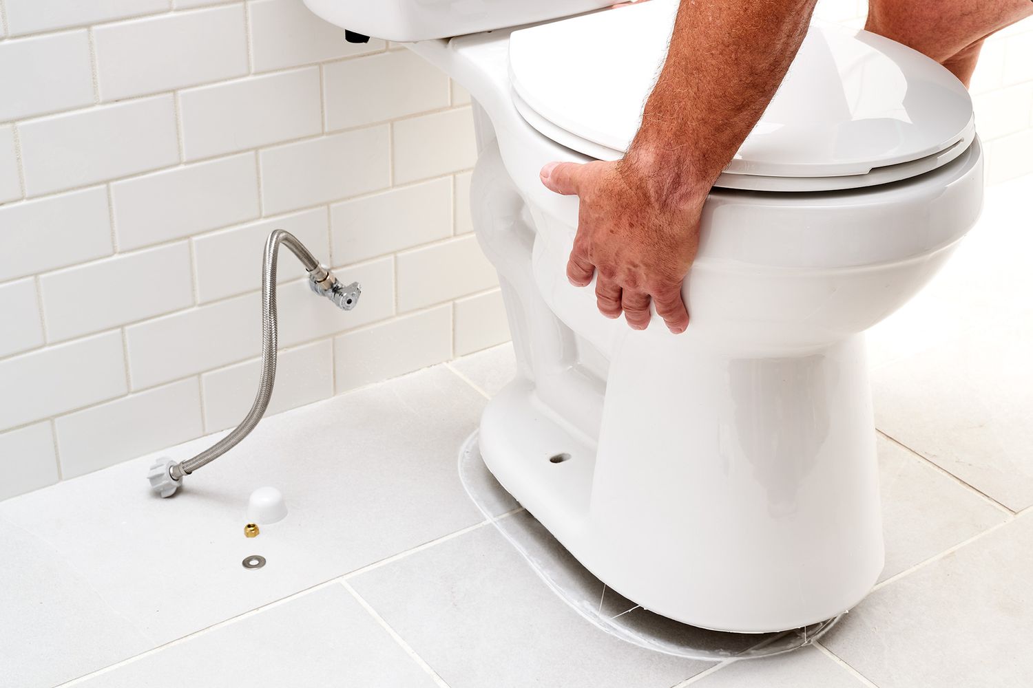 Toilet being removed from bathroom floor