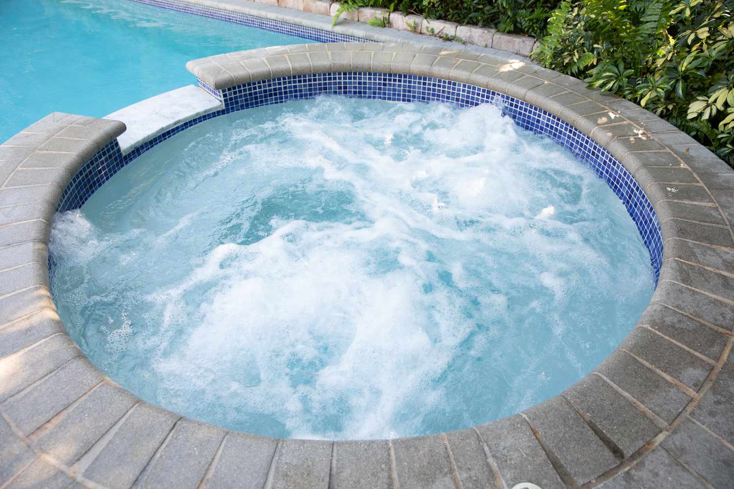 Outdoor hot tub with water churning inside