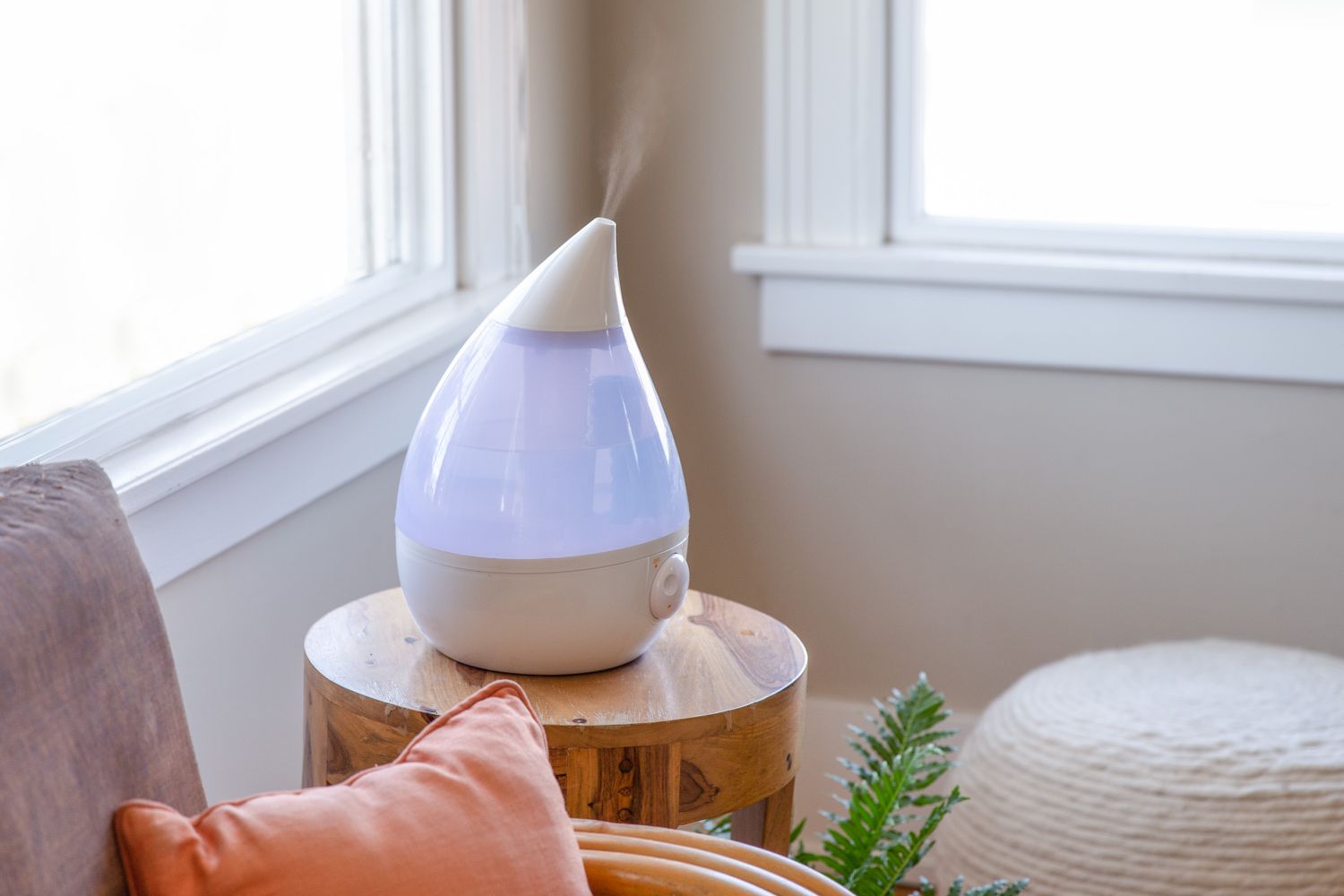 Purple ultrasonic humidifier in room for cooling