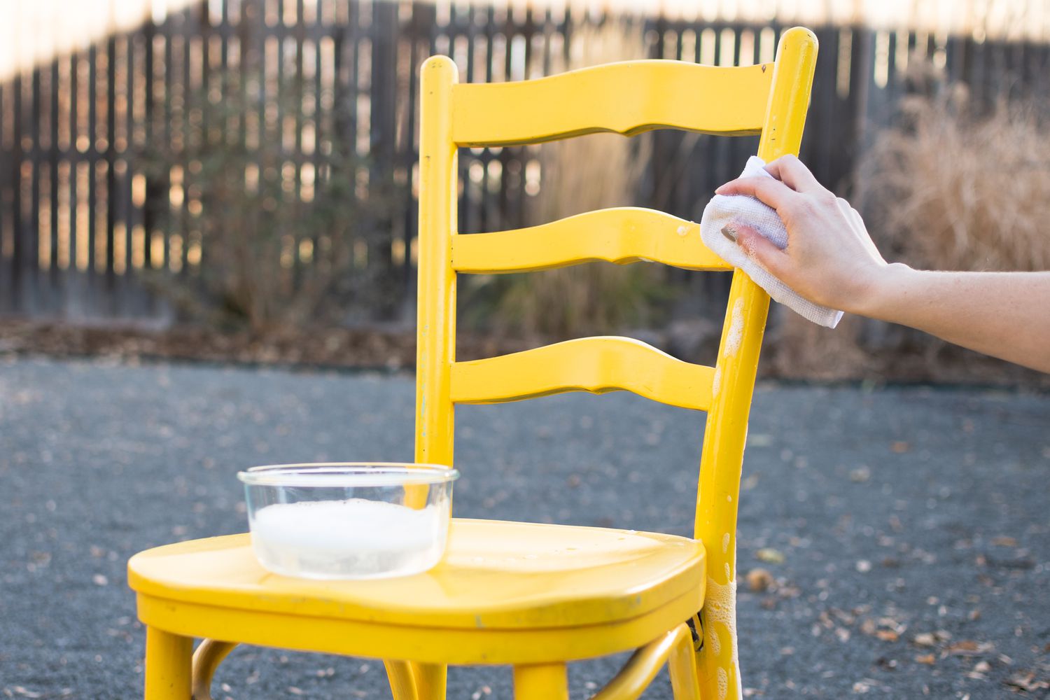 Yellow chair being wiped down damp rag and degreasing soap