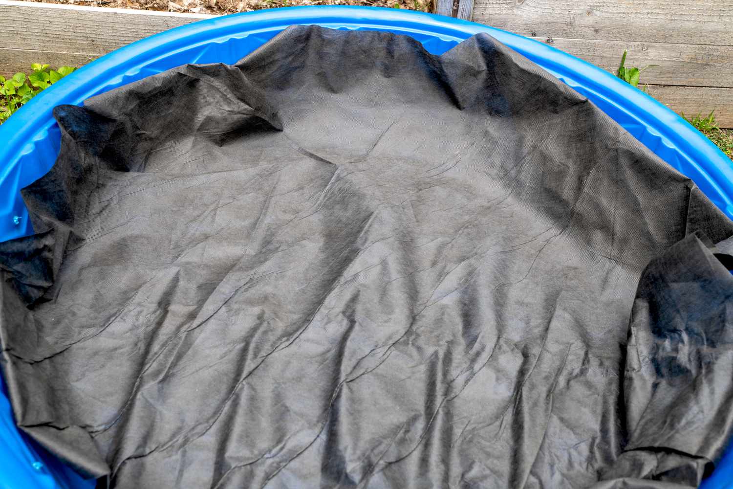 Landscape fabric placed inside kiddie pool