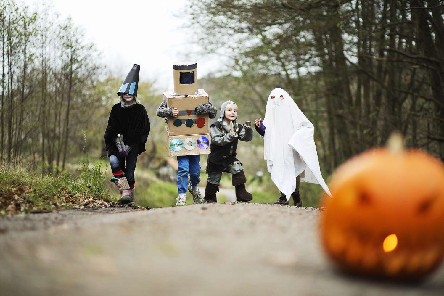 Children wearing Halloween costumes on an outdoor path