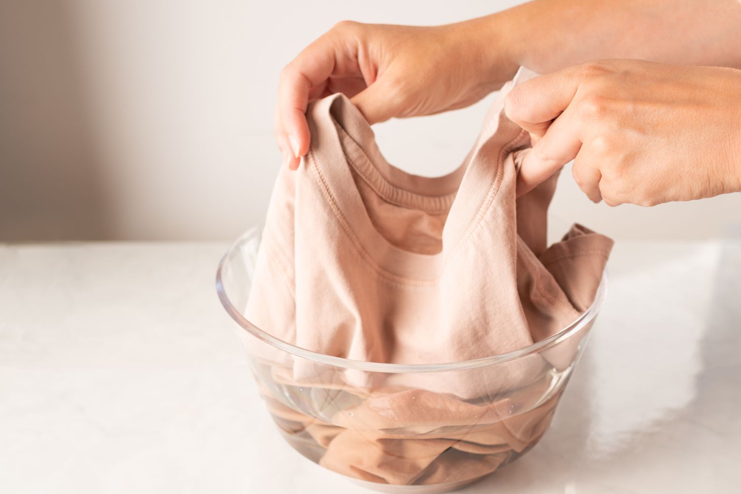 submerging a garment into a bleach solution