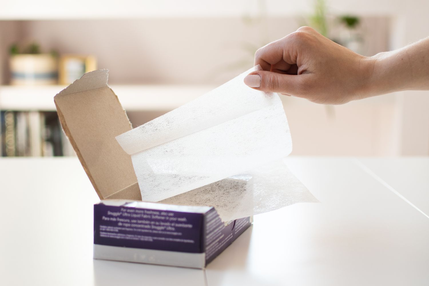 Dryer sheets being pulled from box