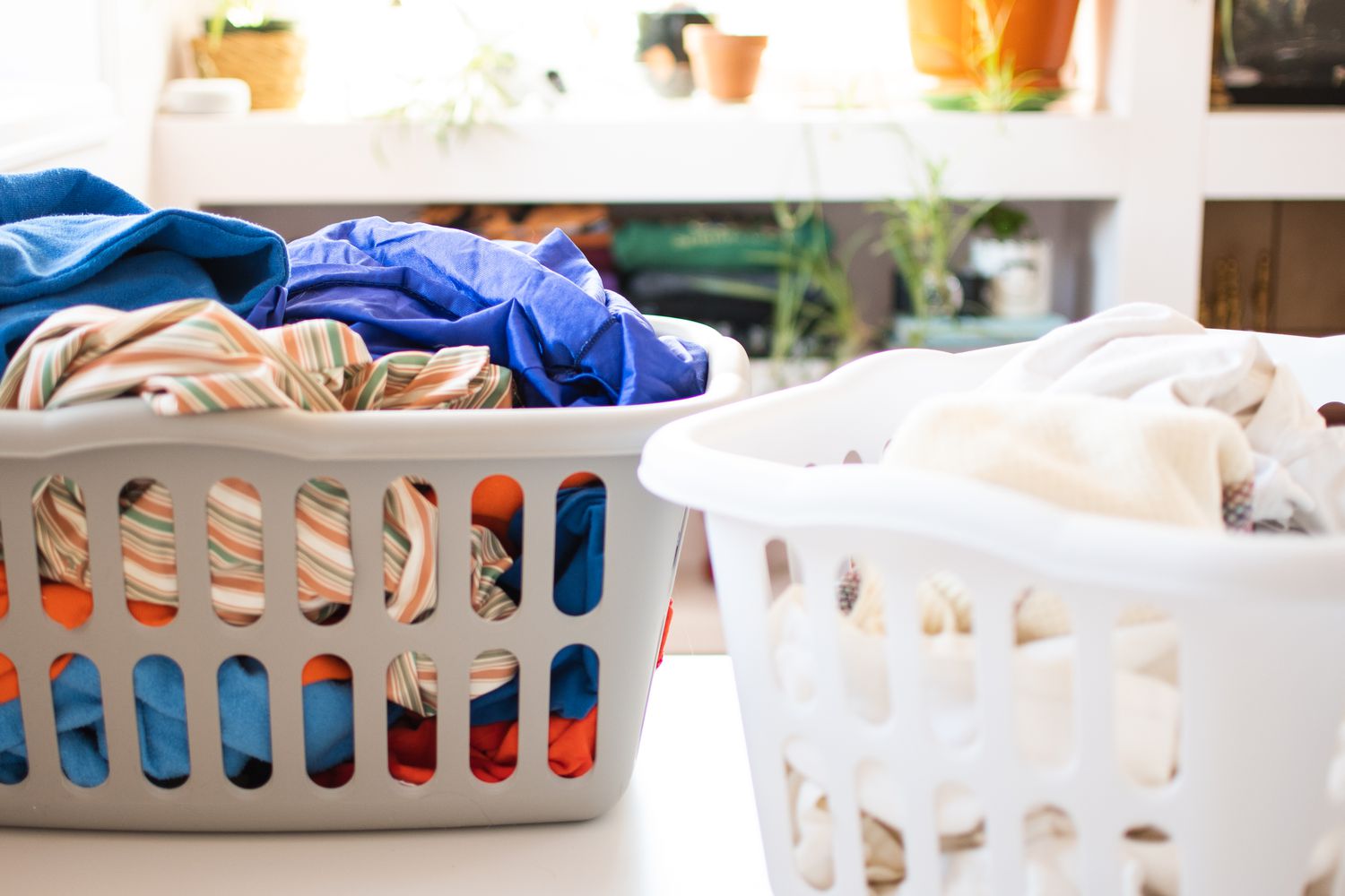 Two laundry baskets with dirty clothes