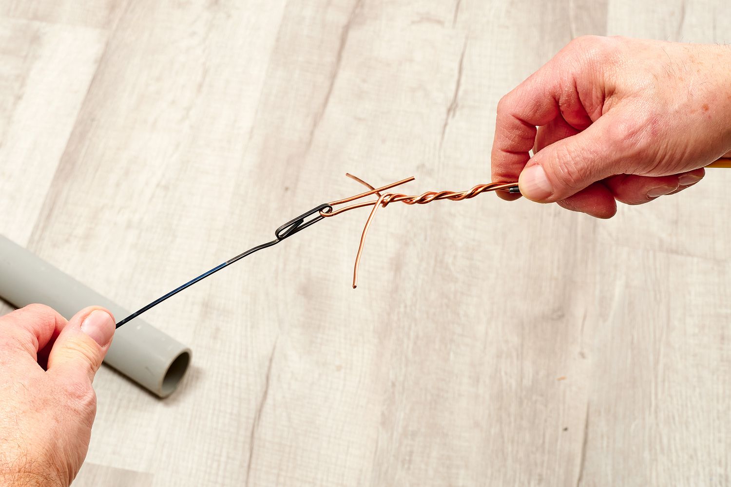 Twisted copper wires attached to fish tape through loop