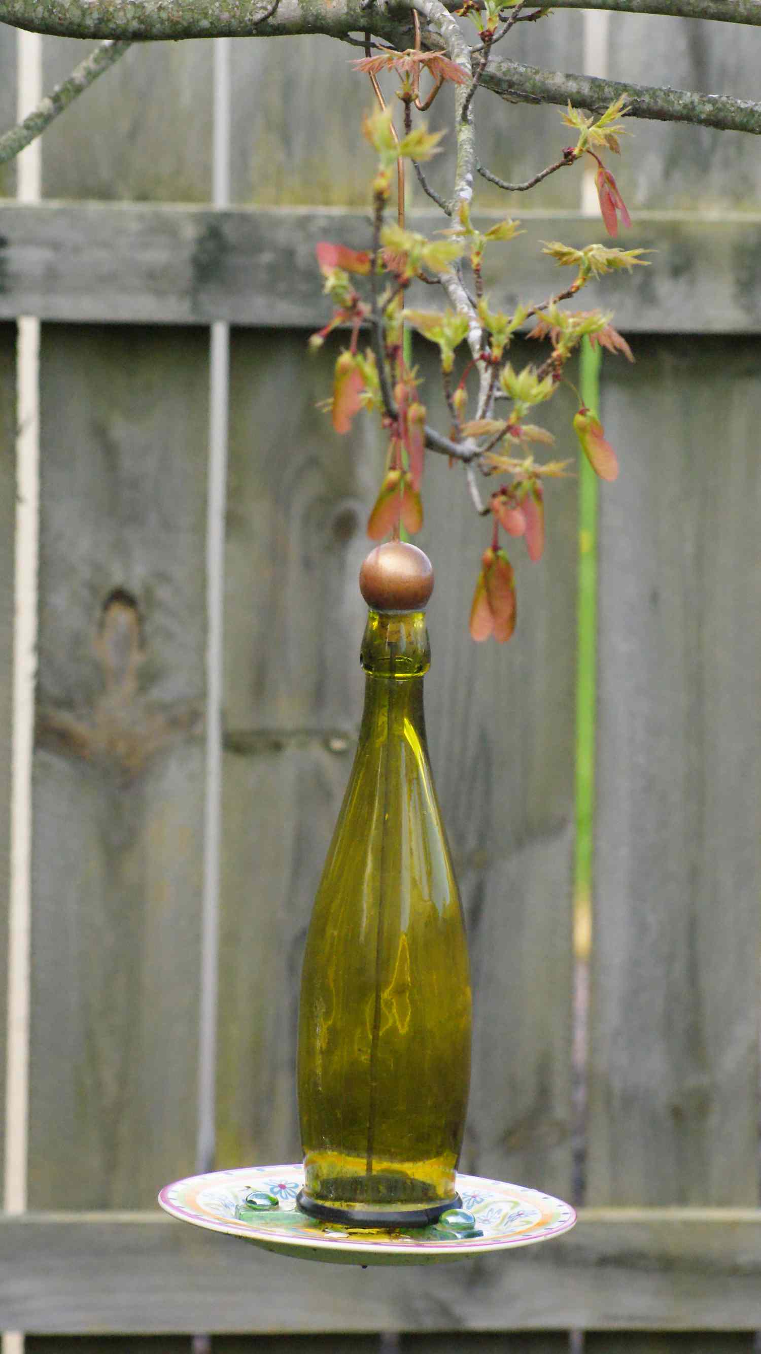 Bird feeder made out of a wine bottle