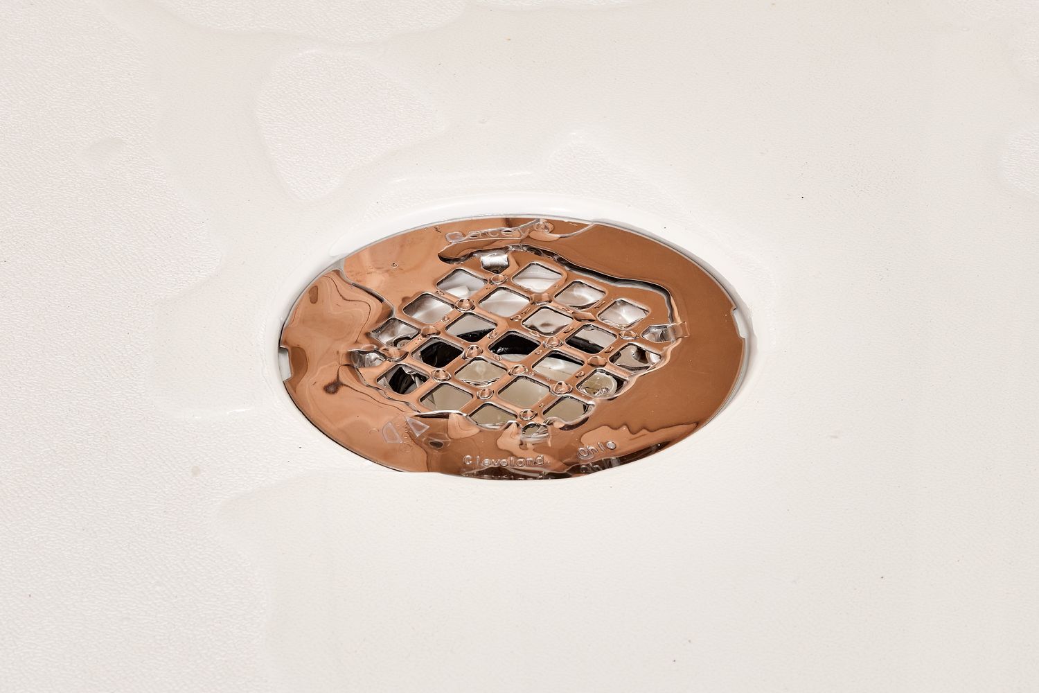 Water surrounding shower drain closeup