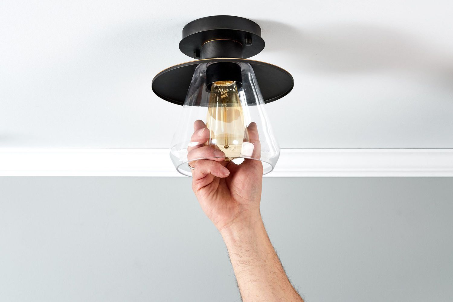 Light bulb being replaced in ceiling light fixture