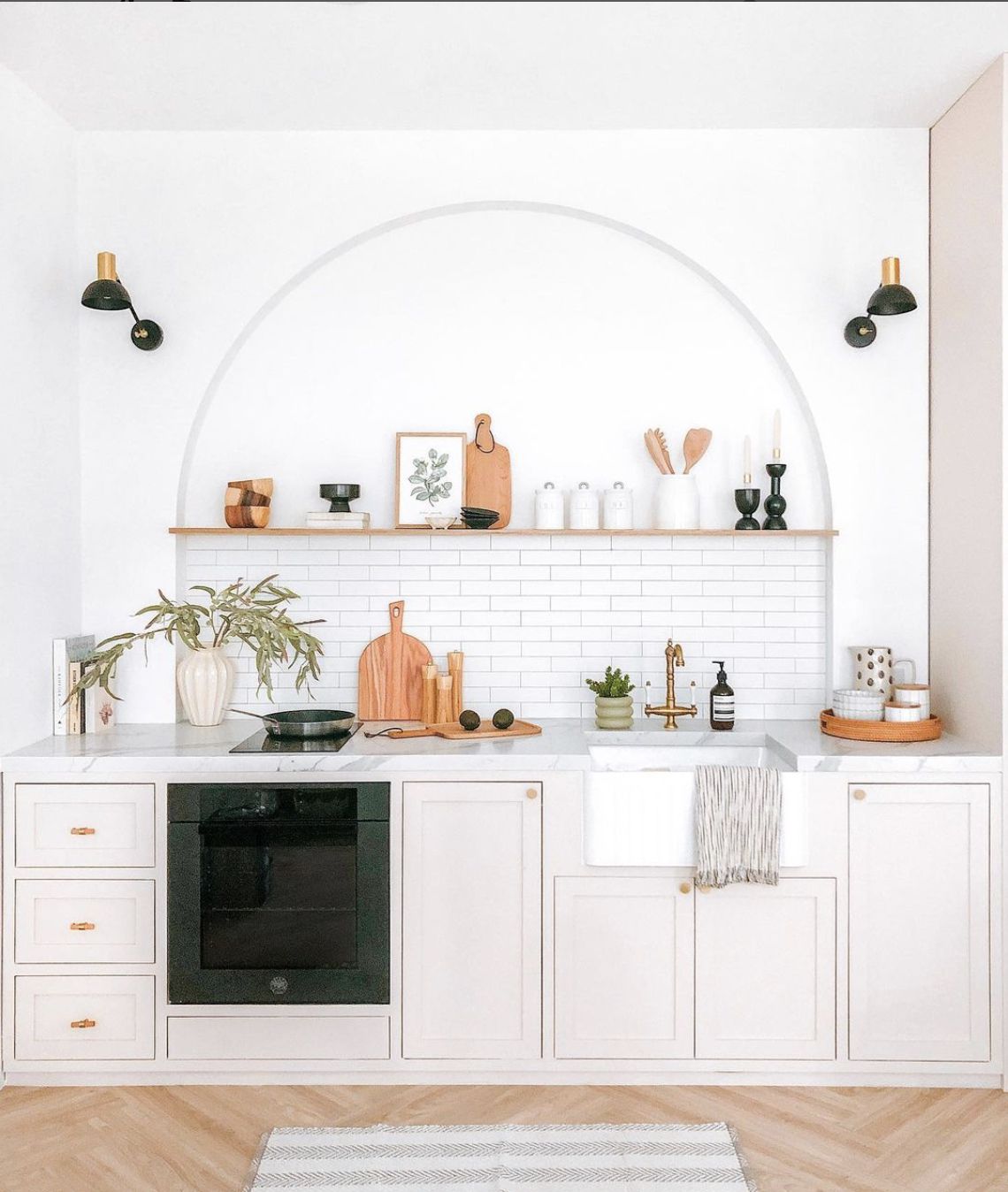 cocina blanca moderna con arco sobre el fregadero y backsplash de azulejos de metro