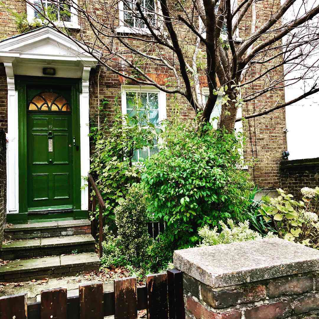 Casa de tijolos com uma porta verde