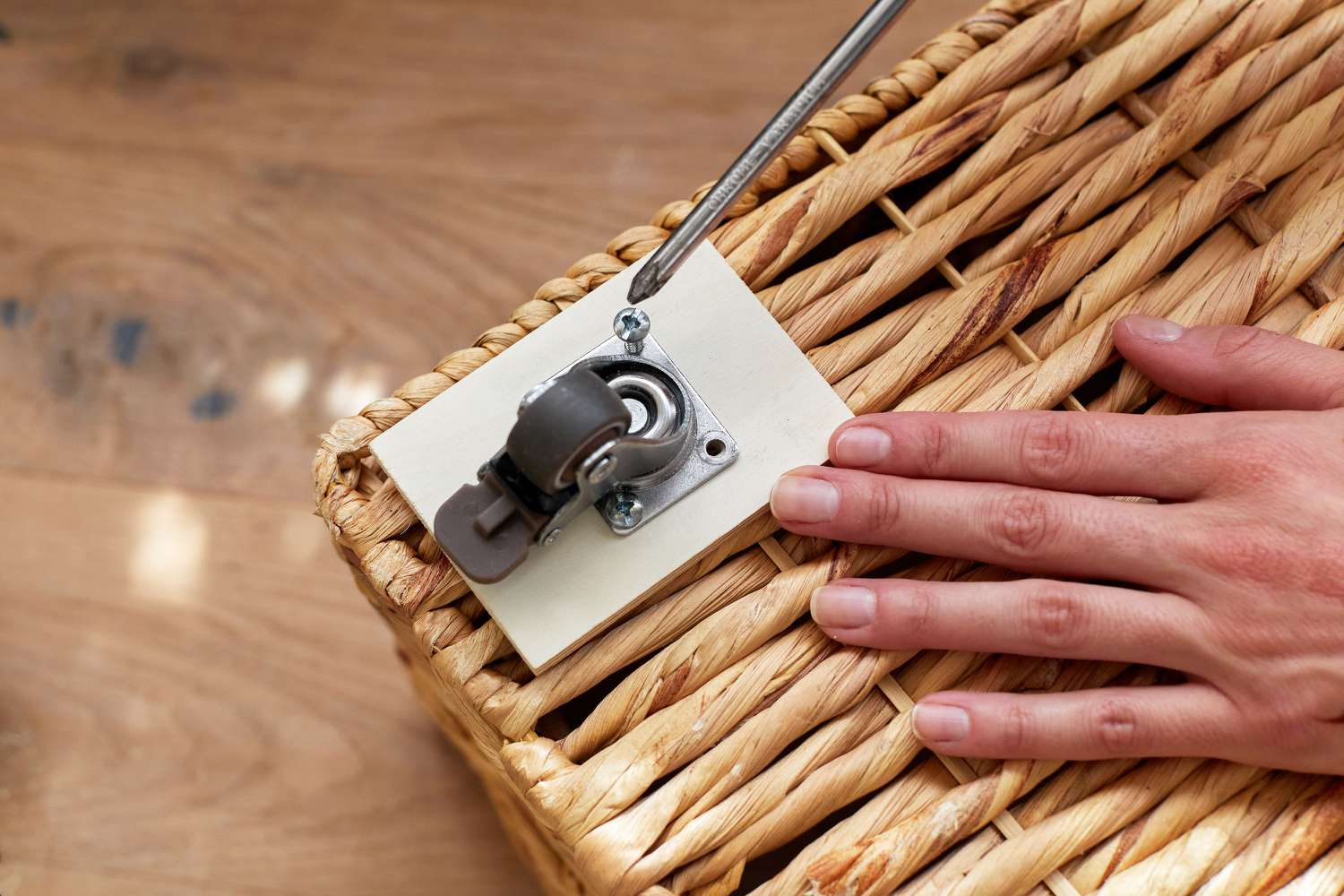 Wheels secured to bottom of basket with screwdriver