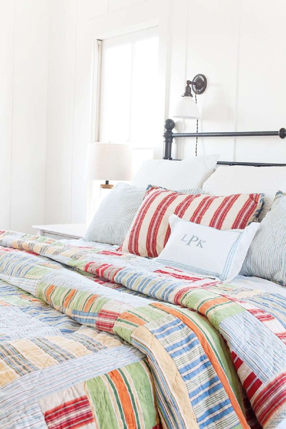 Colorful quilt in farmhouse bedroom