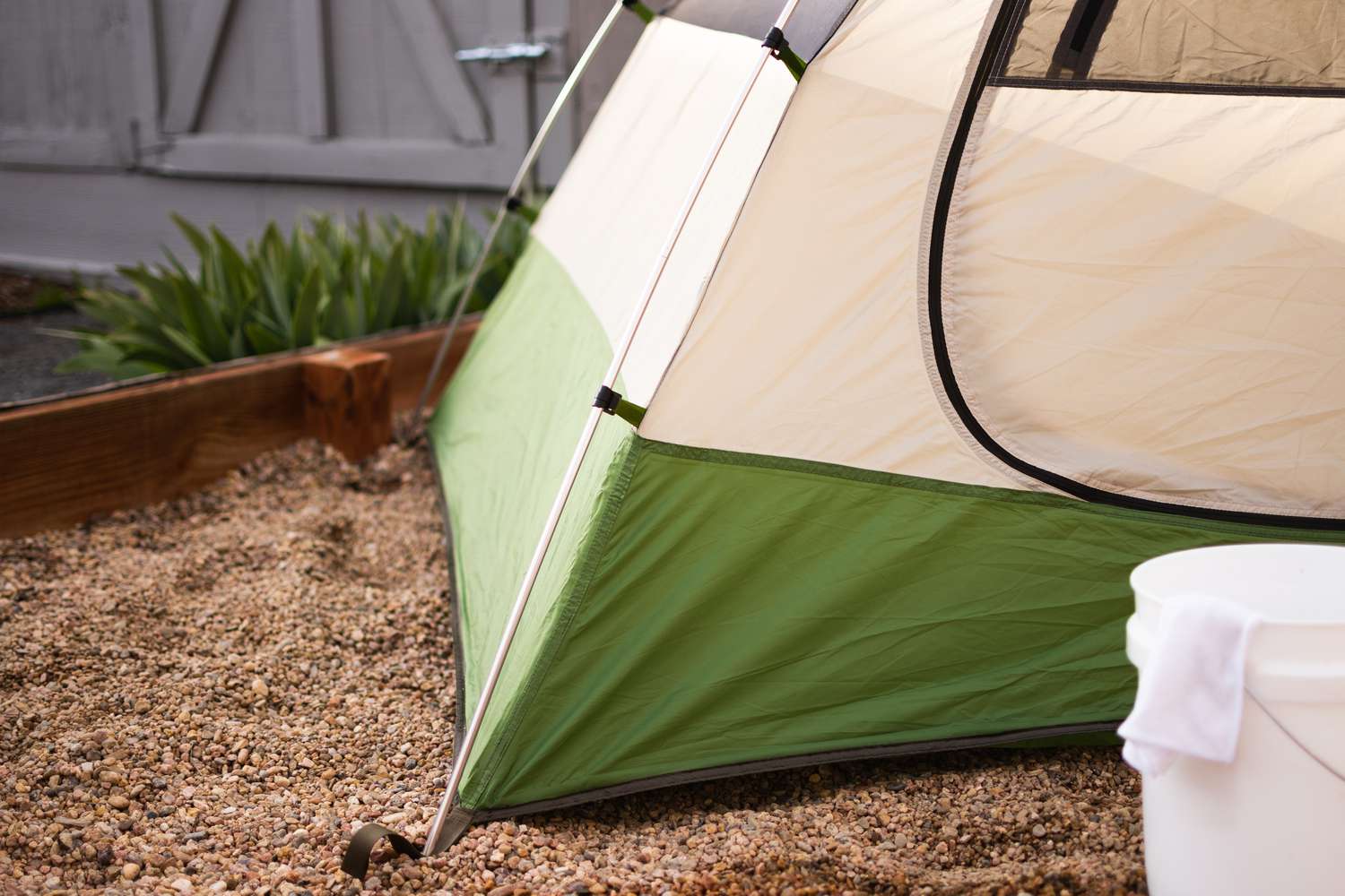 Green and cream colored tent air drying in sunlight with vinegar solution