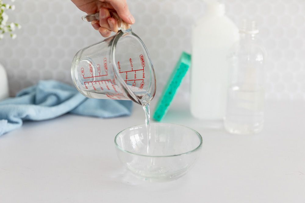 LCD cleaner poured into small glass bowl for sticky messes on screens