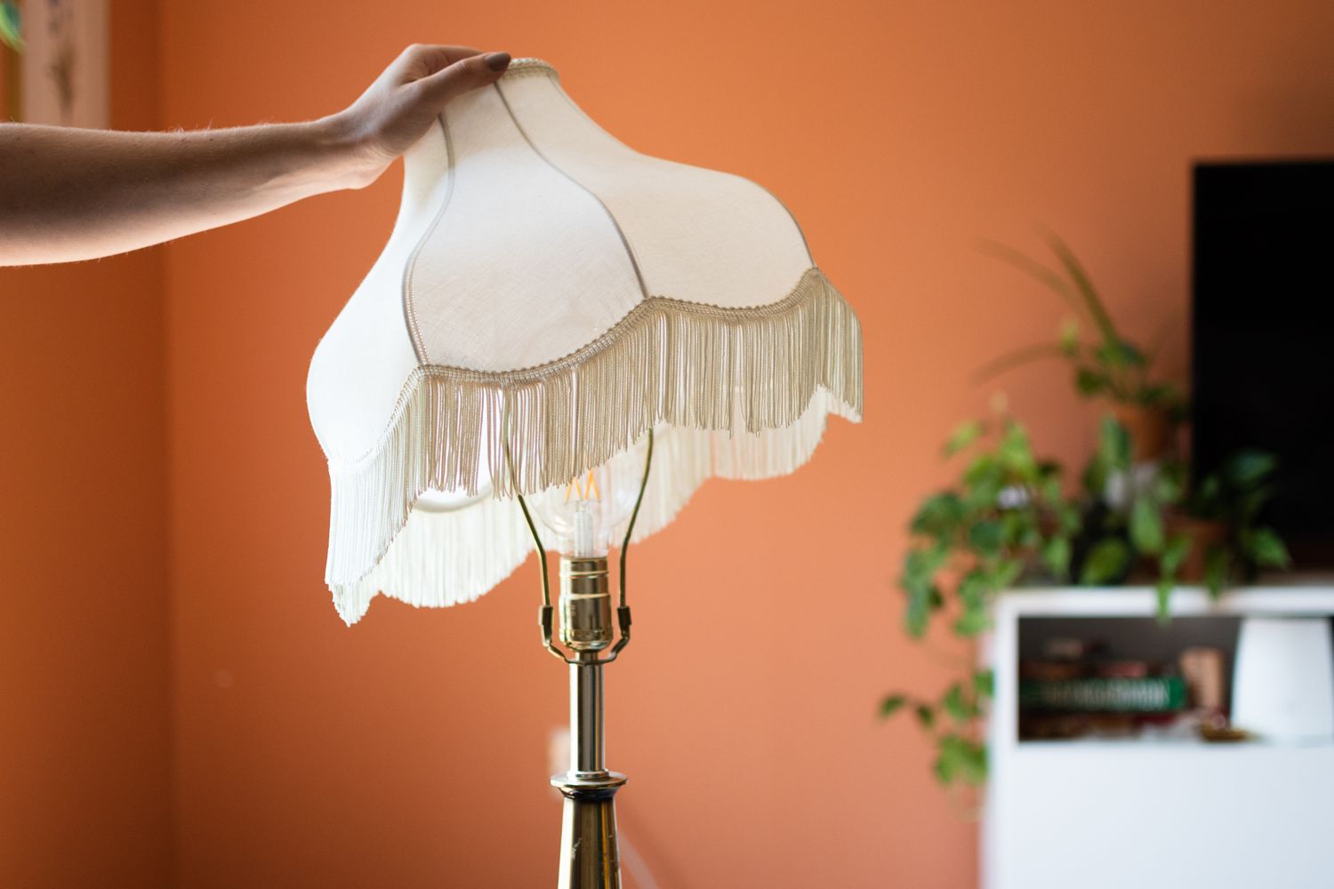 White lampshade with fringes reattached to gold lamp base