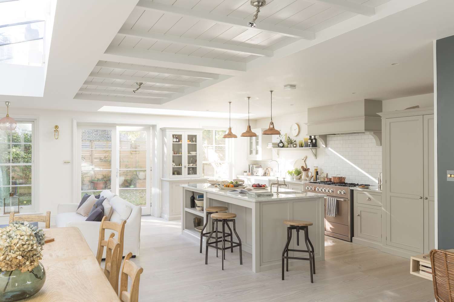 bright spacious white kitchen and dining table