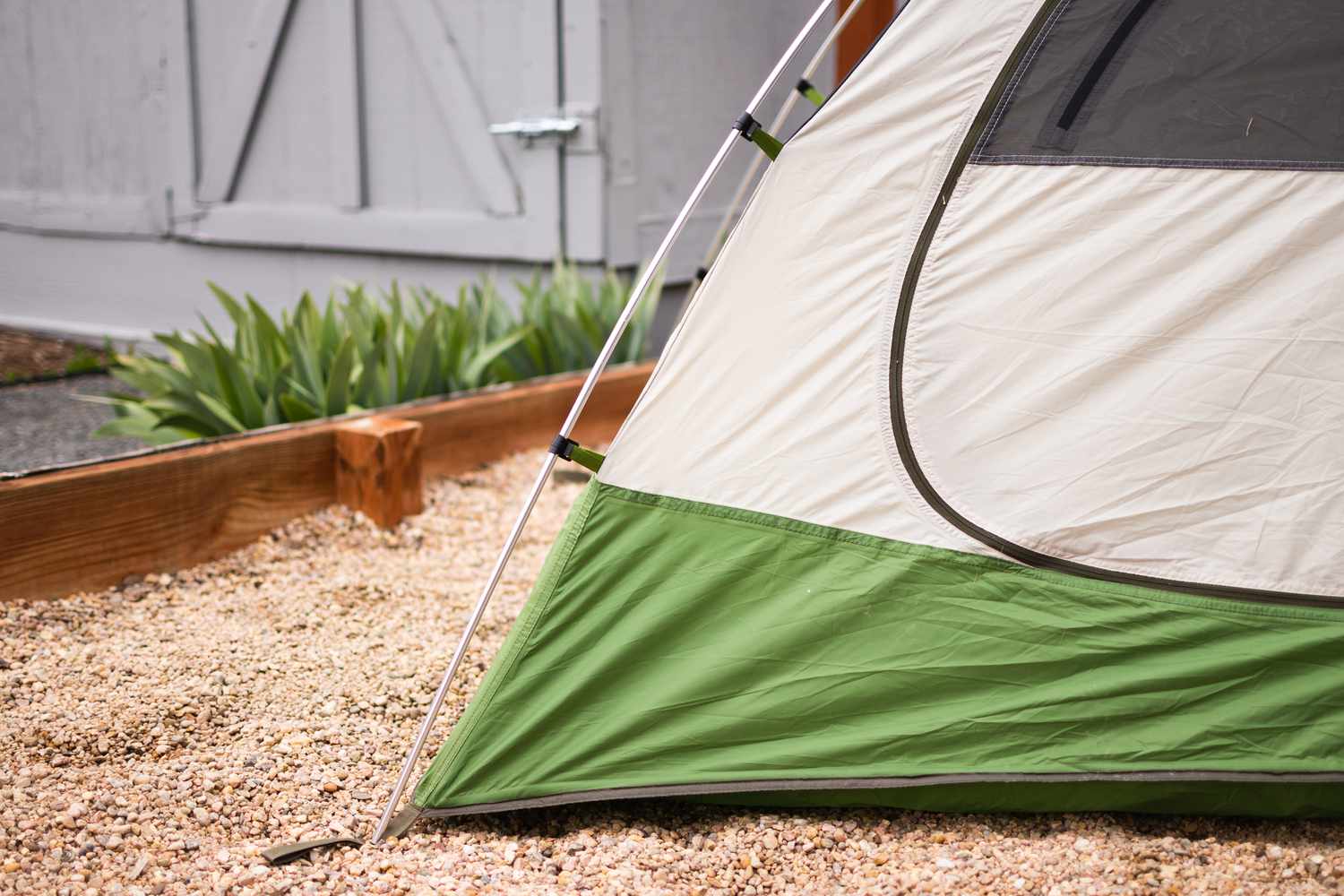 Green and cream-colored tent pitched to cleaning location