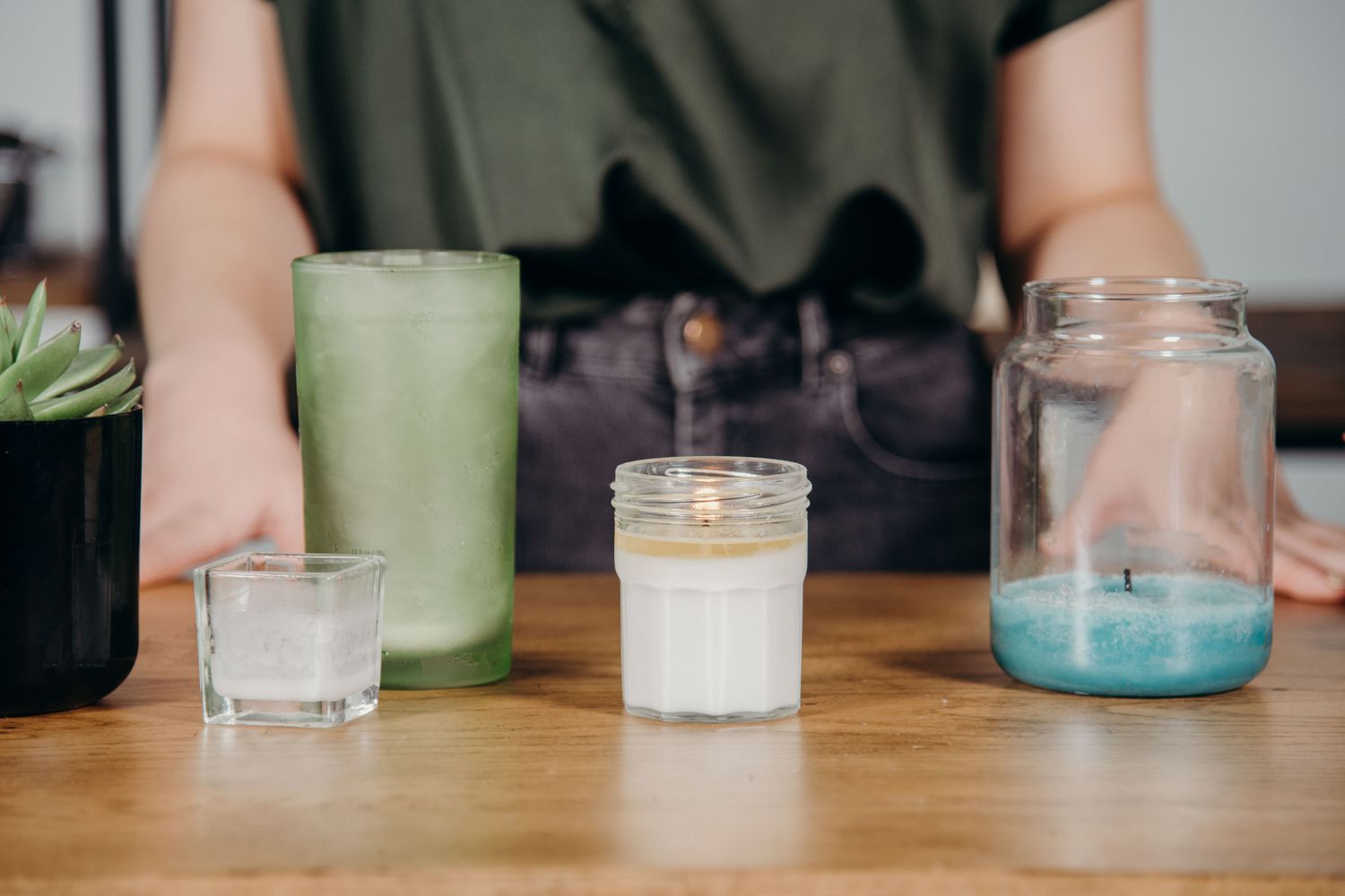 Woman standing behind candle jars