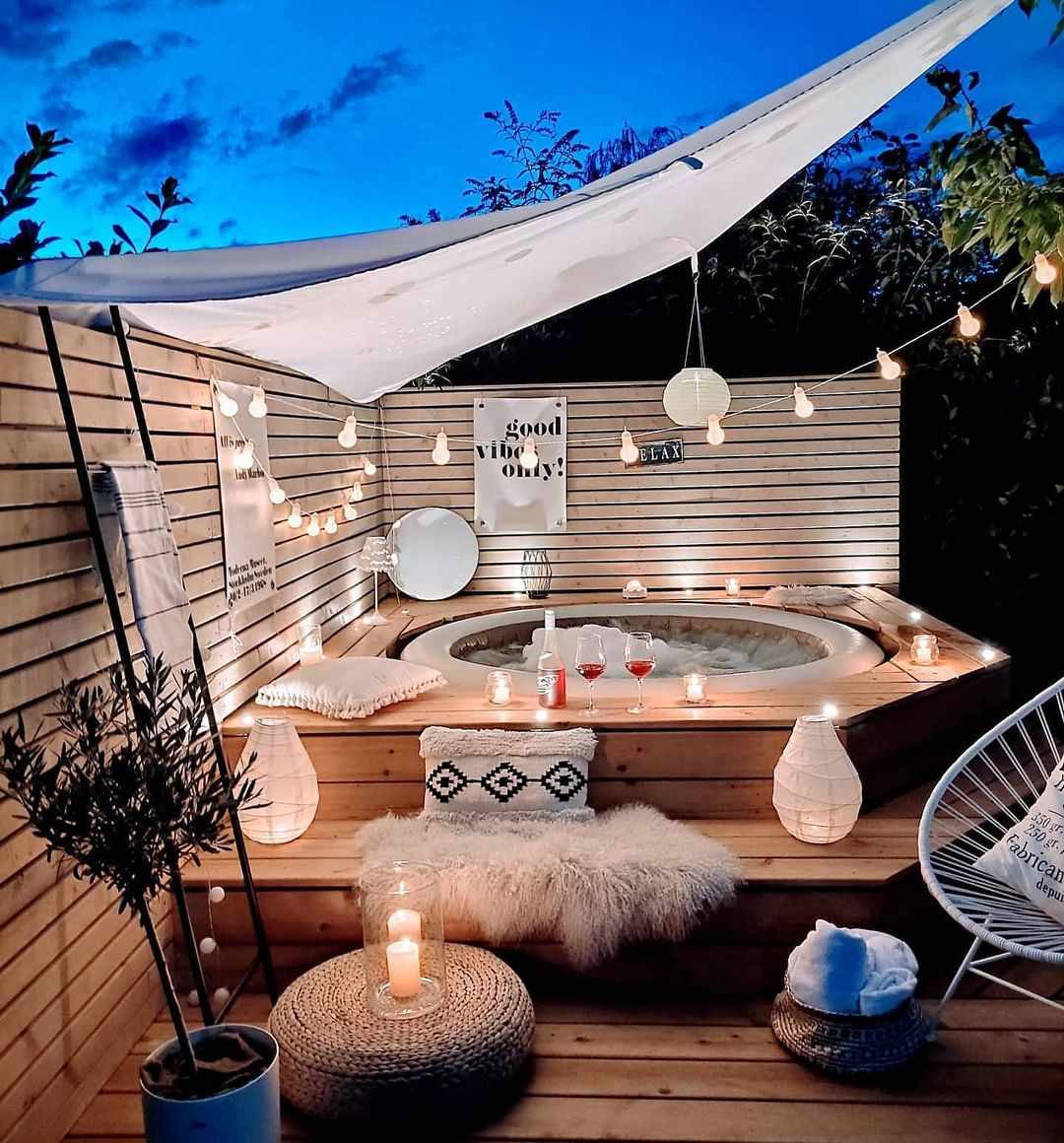 Sun shade with string lights over hot tub