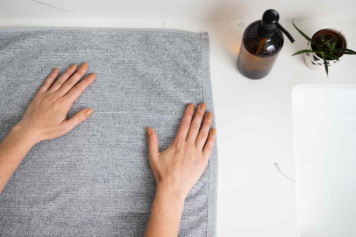 Gray towel laid front side down with wrinkles smooted out