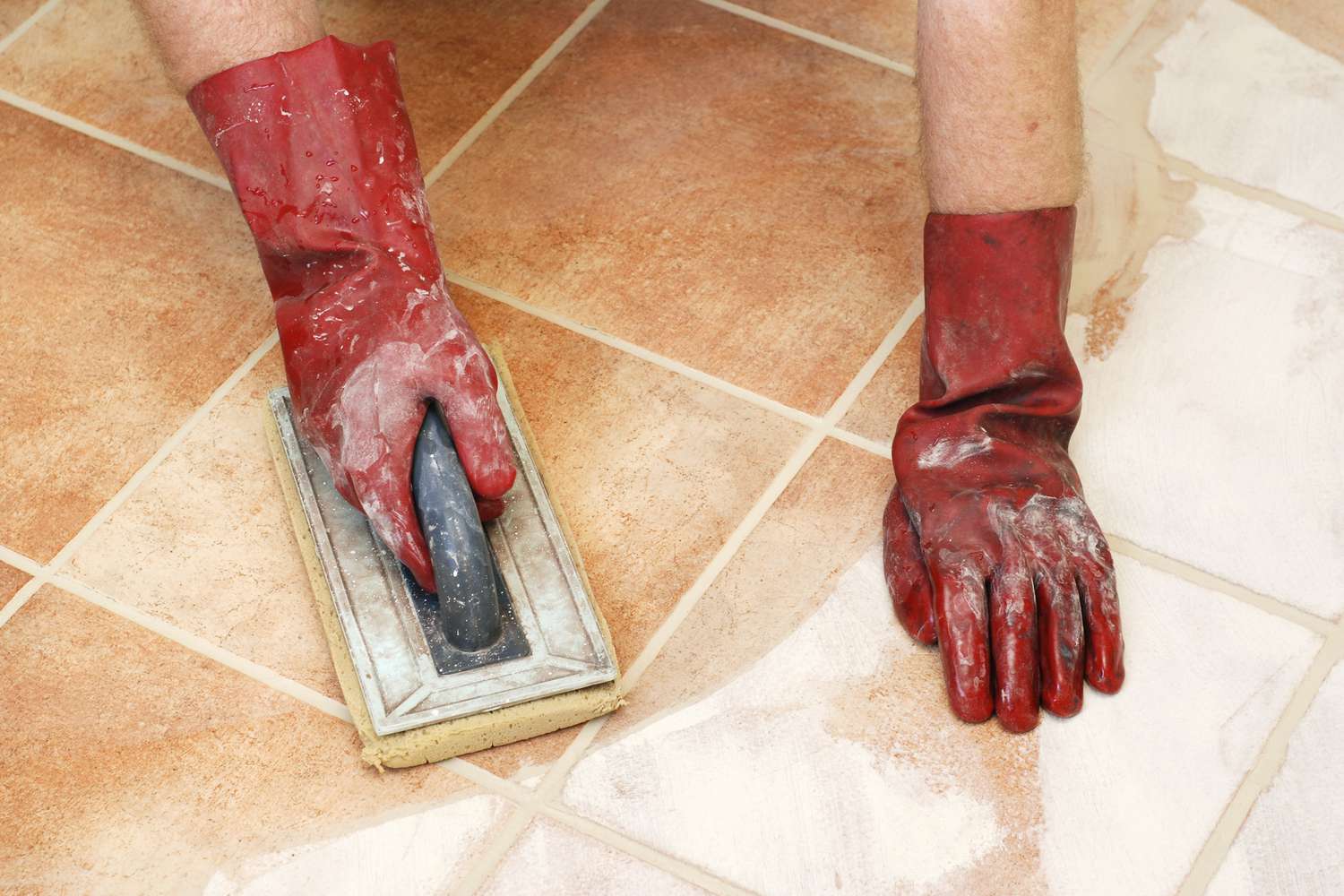 Cleaning off excess tile grout.