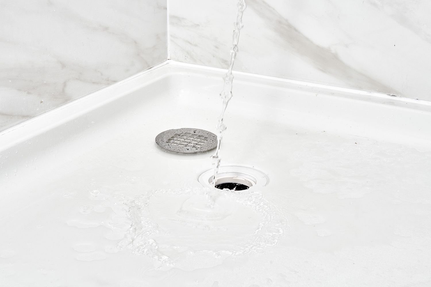 Shower drain flushed with water to loosen debris