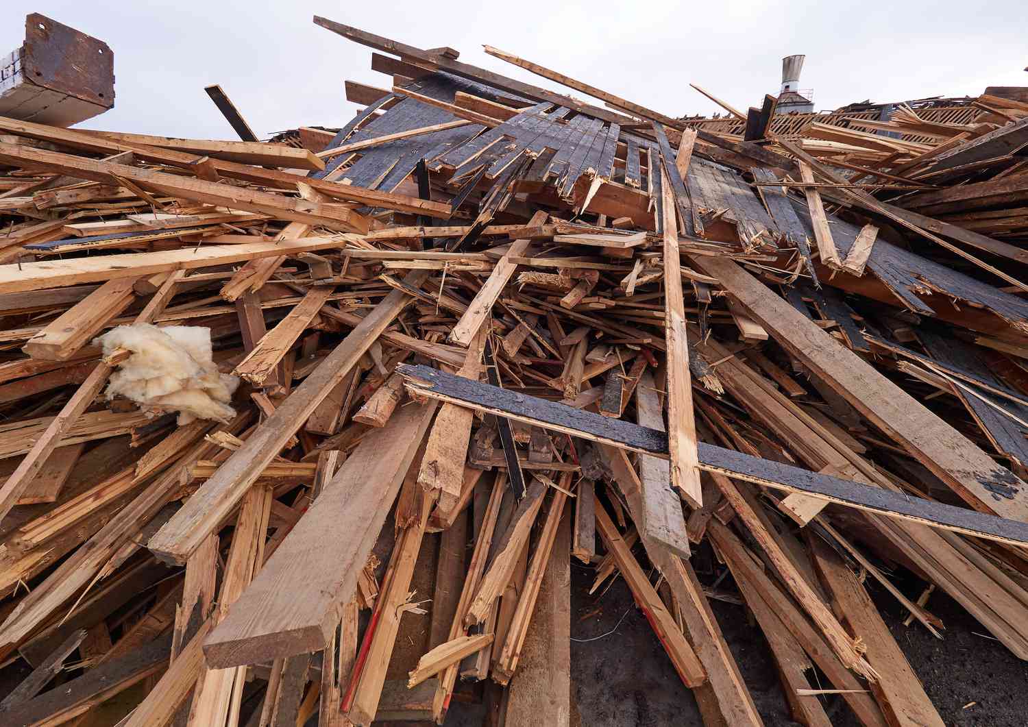 Stapel von Holzbrettern auf dem Abbruchgelände, bereit für das Recycling