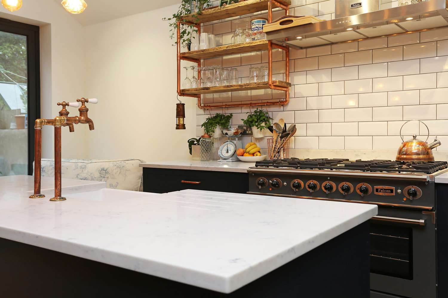 Bancadas de mármore branco com um backsplash de azulejos brancos.