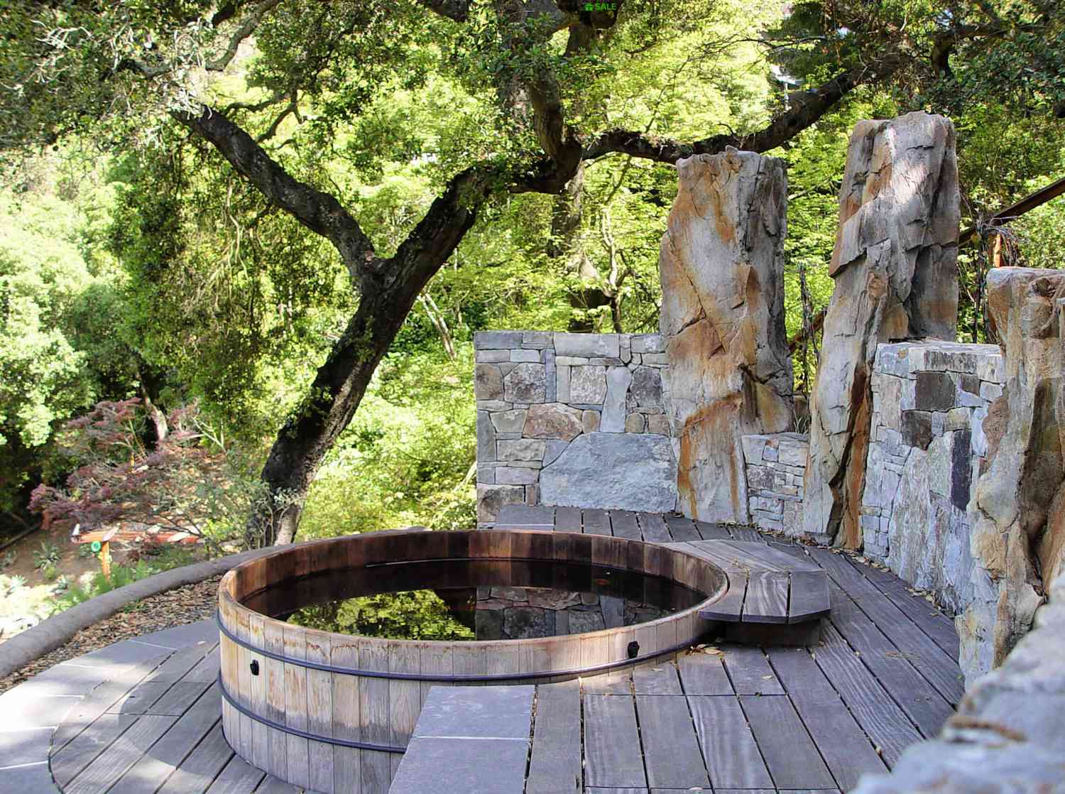 design de banheira de hidromassagem redonda de pedra e madeira