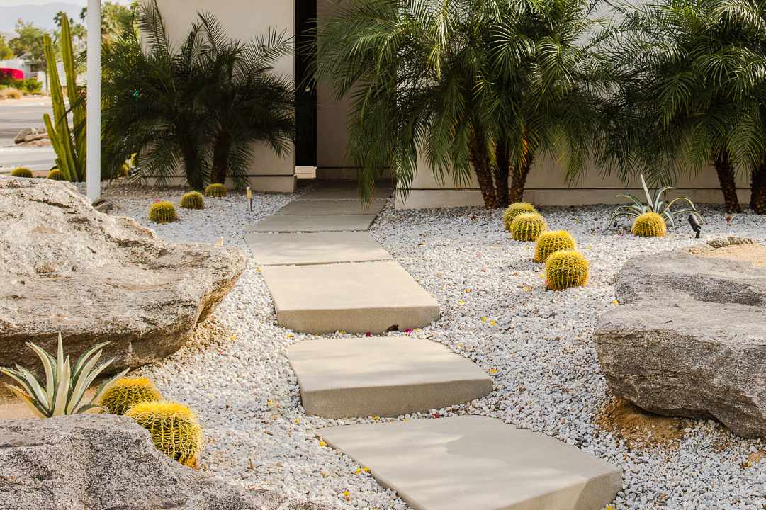 Rock garden with large stone pathway leading to front door