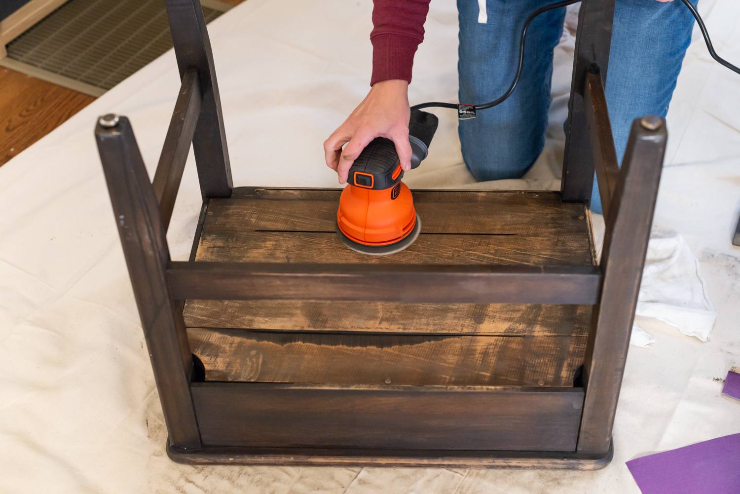 sanding the wood with a random orbital sander