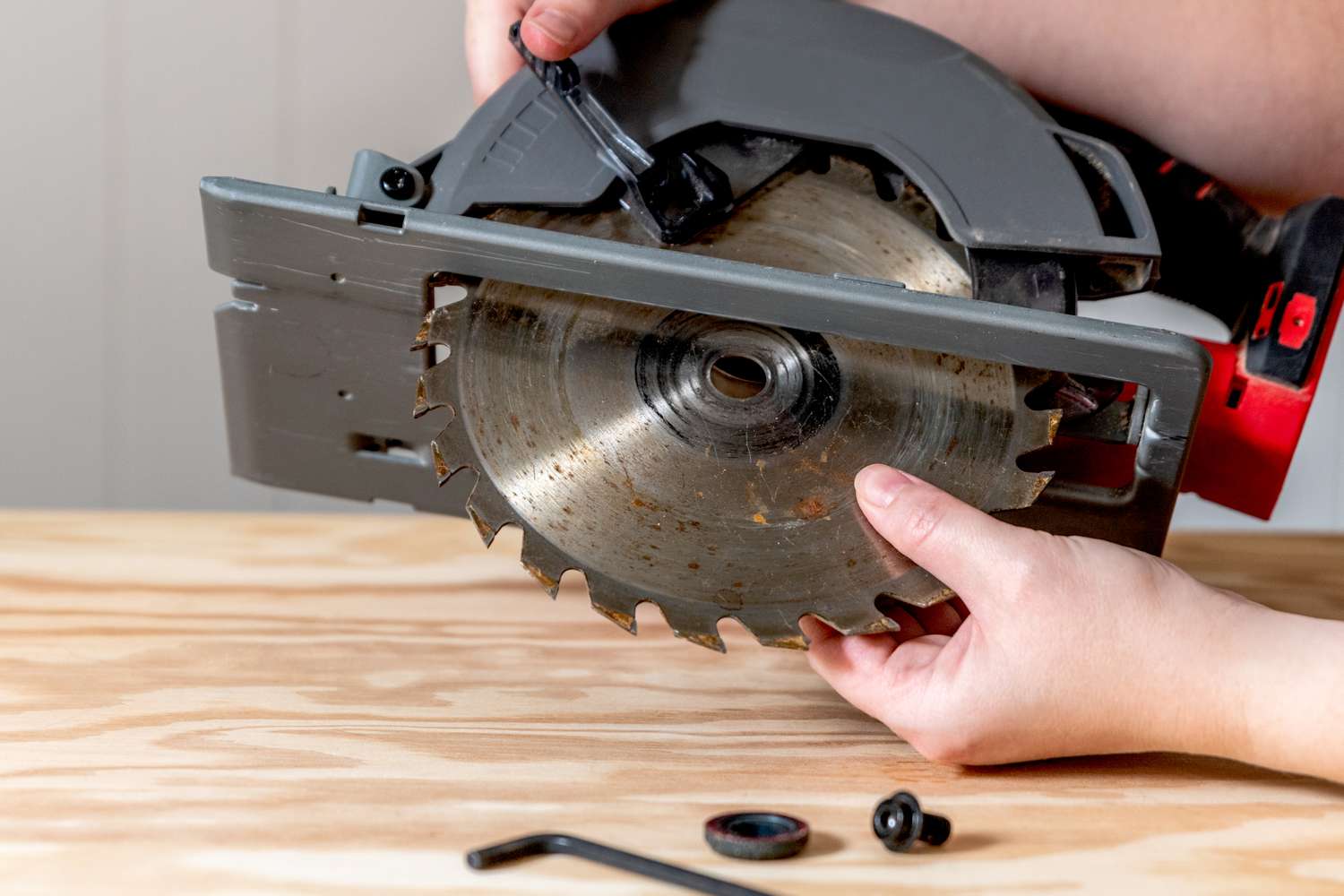 Dirty saw blade removed from unplugged saw machine
