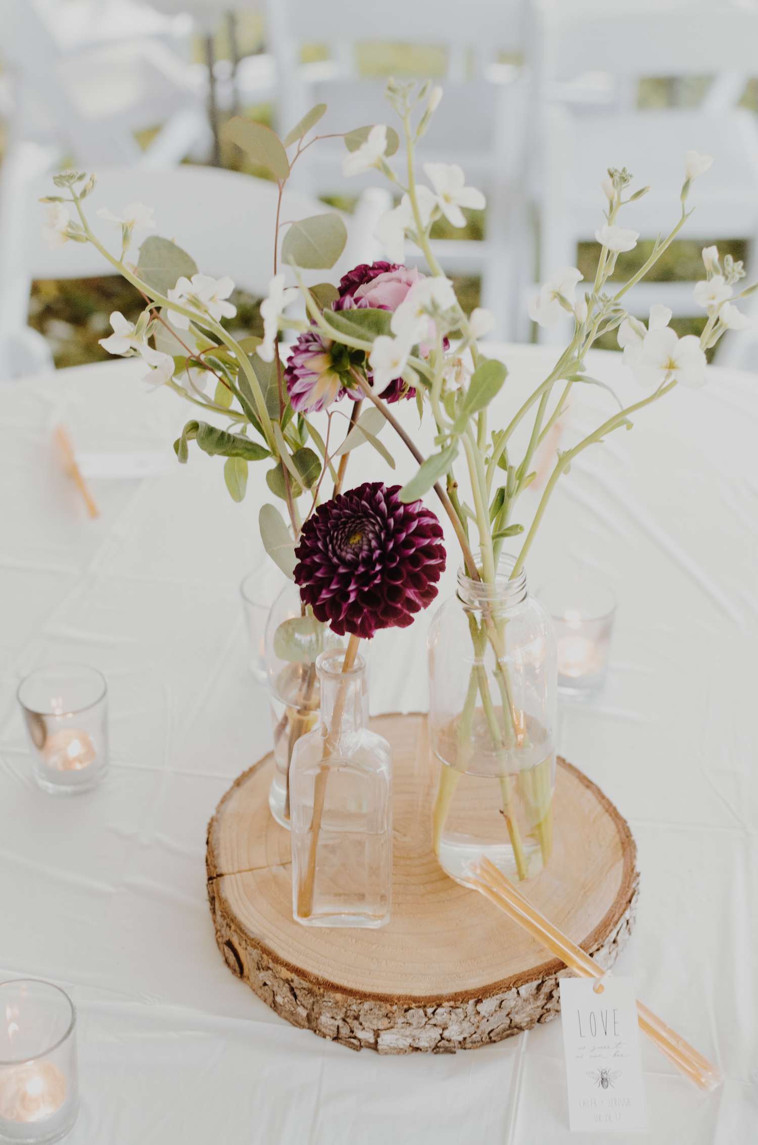 purple and white flowers in glass vases