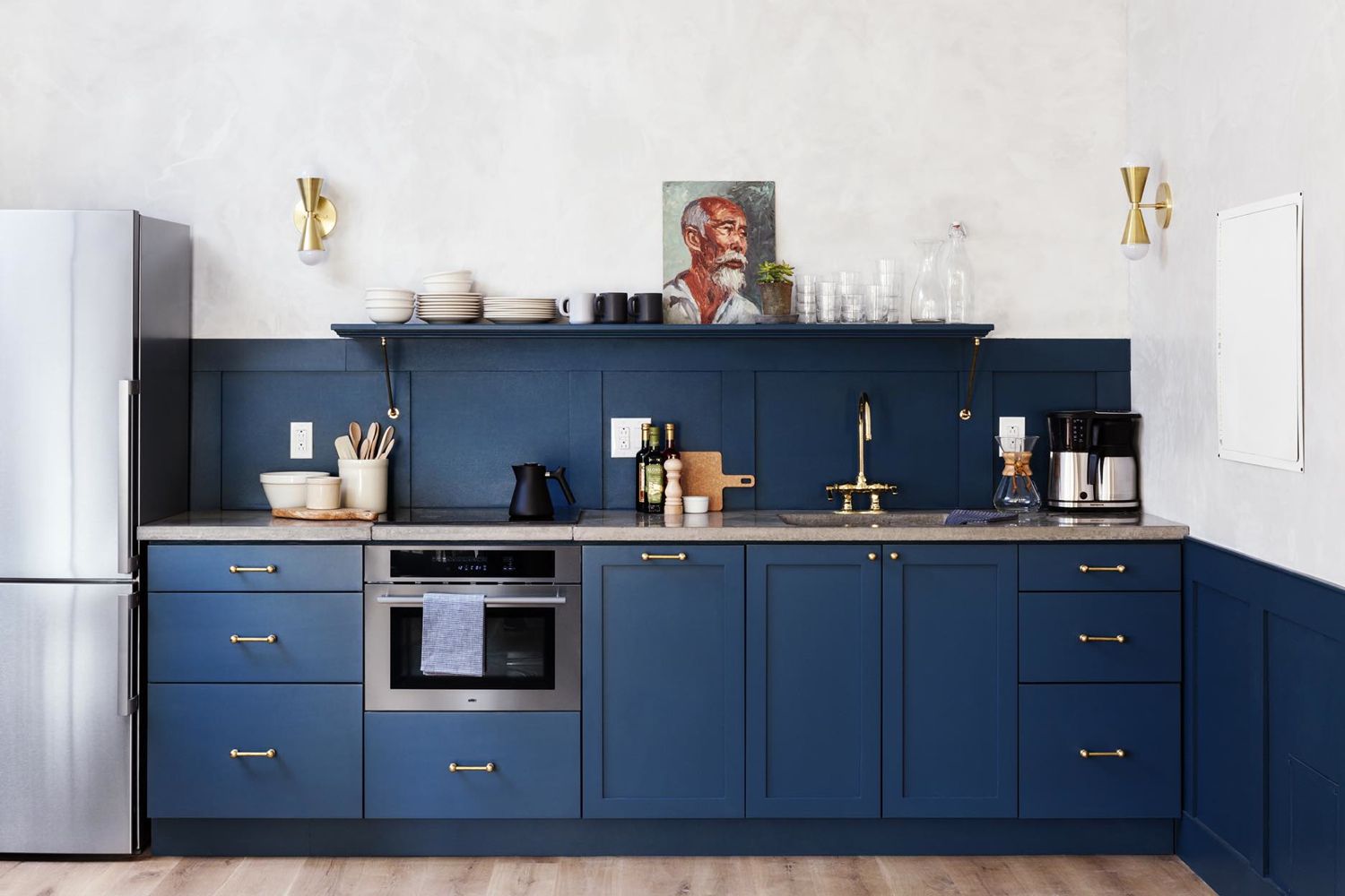 Navy blue kitchen with gold accents at Lokal Hotel.