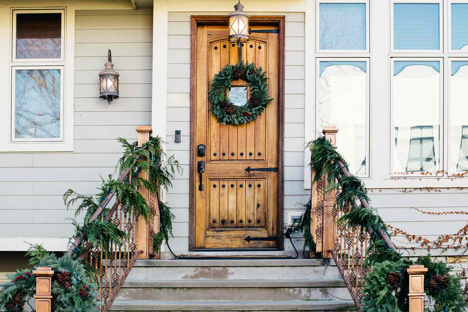 Front door entrance covered with natural Christmas decorations