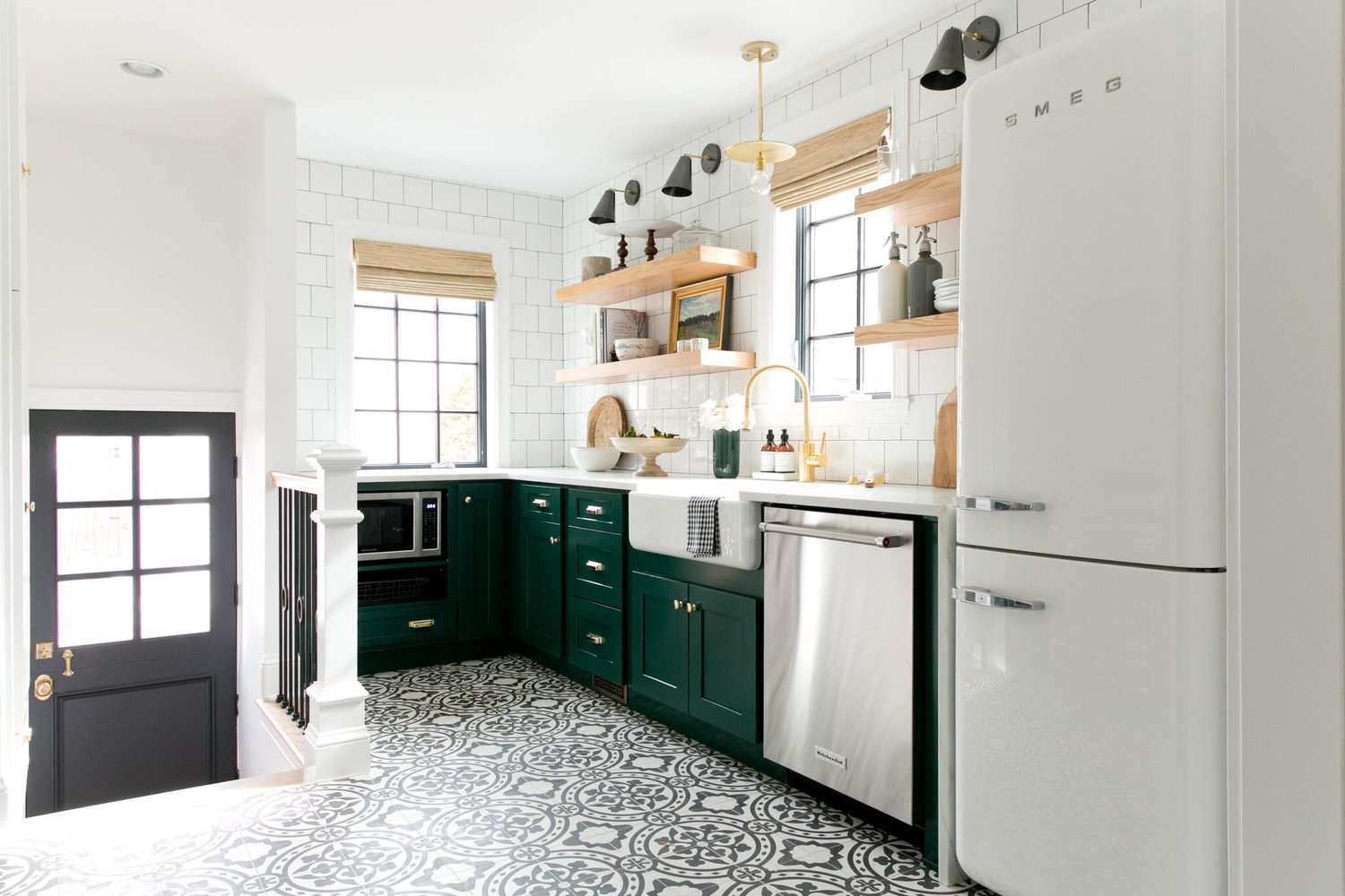 Küche mit grünen Schränken und gemusterten Bodenfliesen
