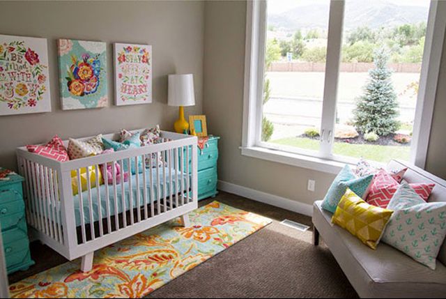 Neutral nursery with colorful teal, yellow and floral accents.