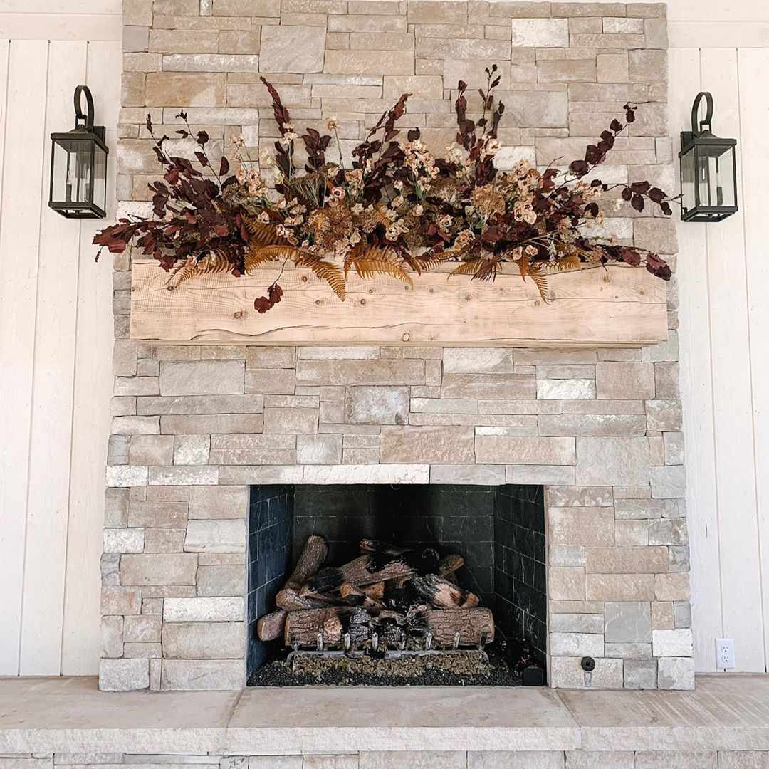 floral arrangement above fireplace on mantel