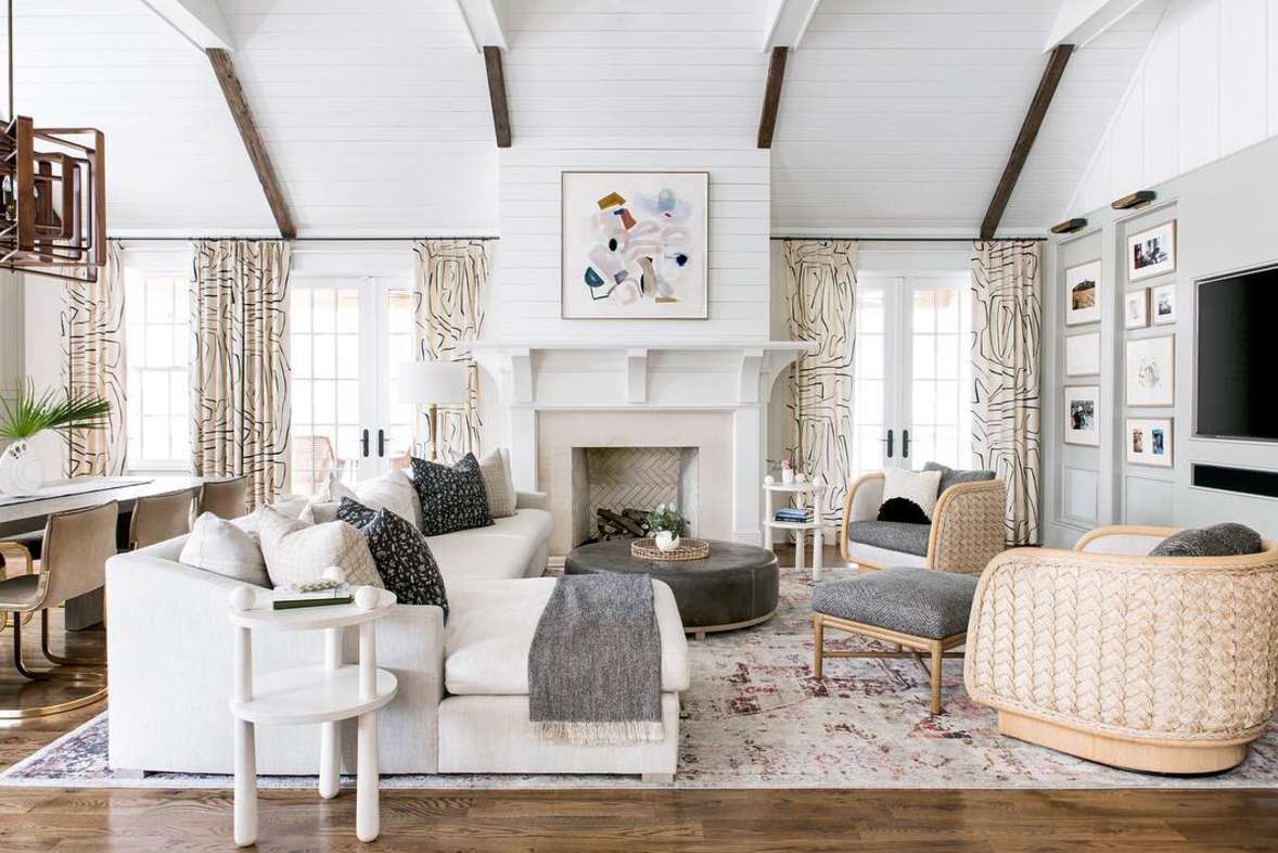 living room with high beams and white color palette