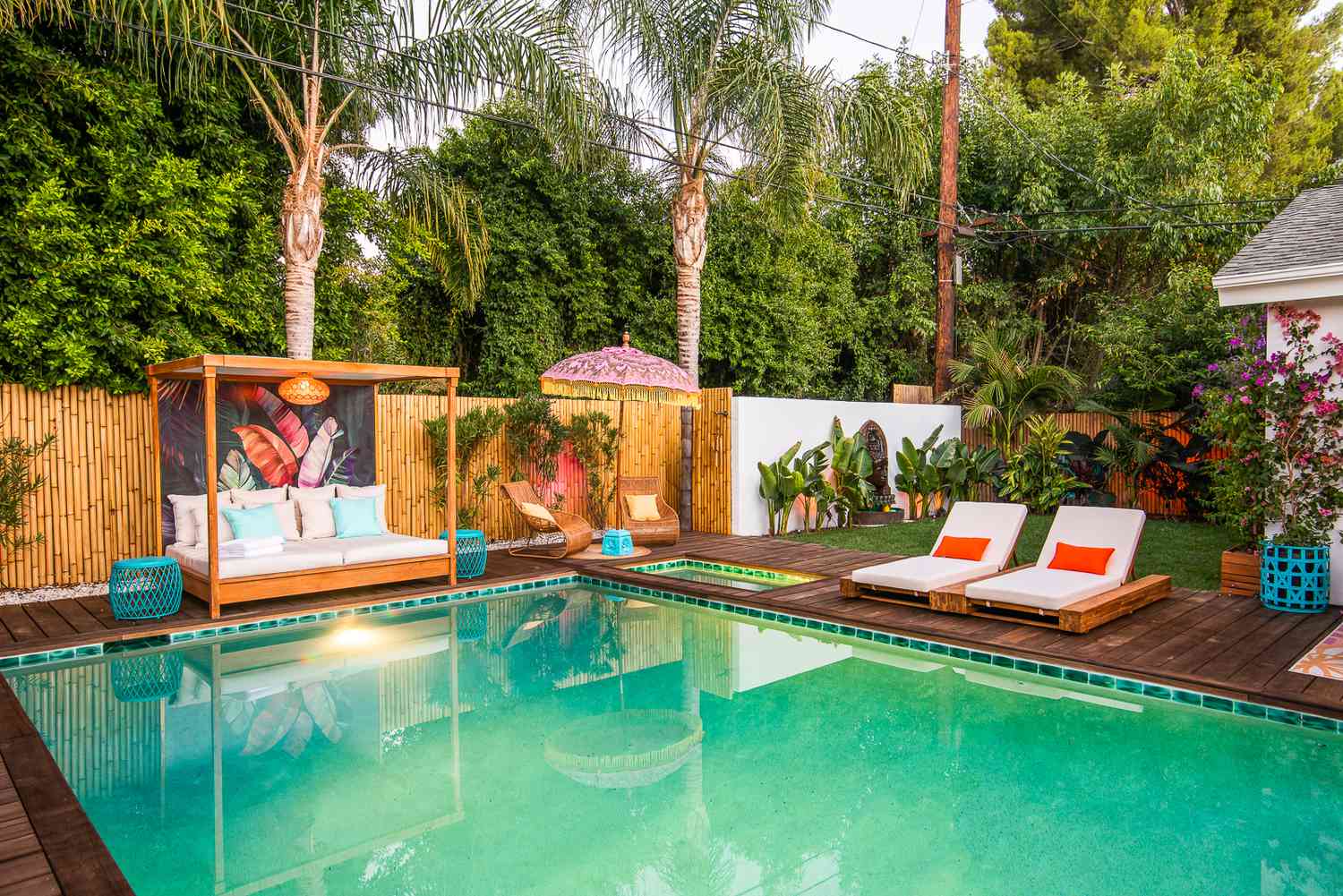 Outdoor pool area with bamboo fencing and day bed