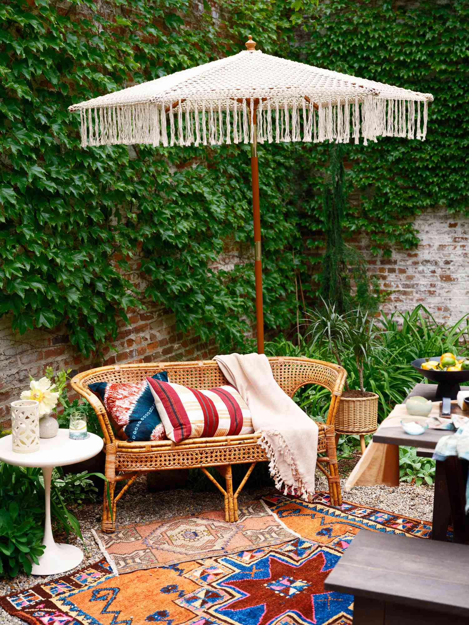 macrame umbrelly sits among a settee, and colorful rugs and throw pillows