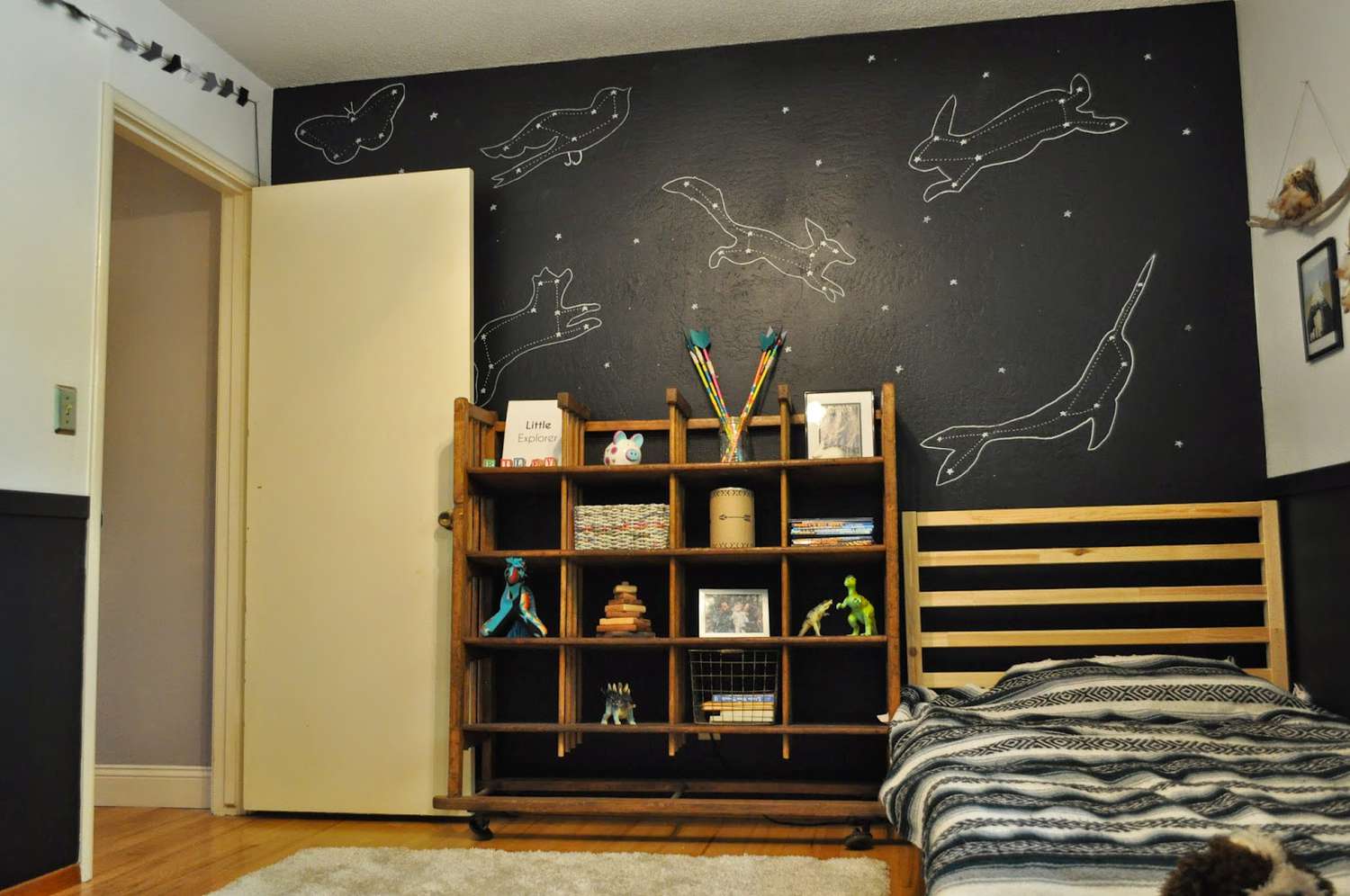 kids room with black accent constellation wall