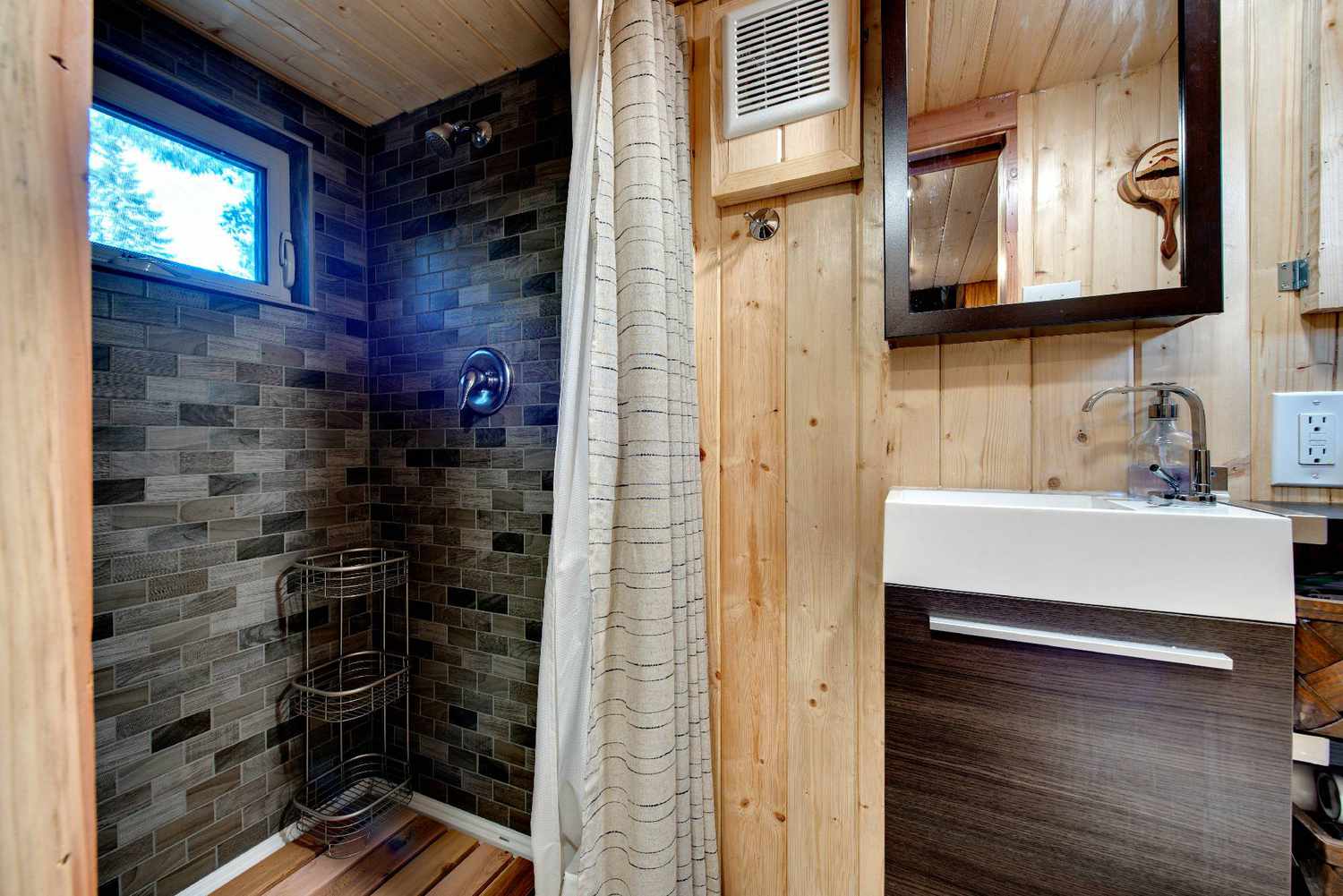 hero tiny house bathroom with gray tile