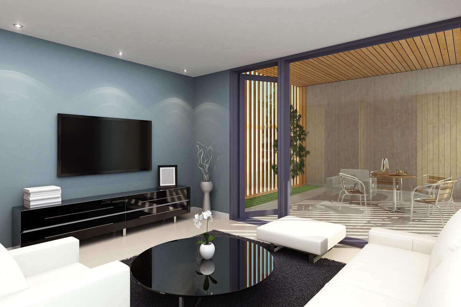 Deckeneinbauleuchten in einem blauen Wohnzimmer mit montiertem Fernseher und weißen Sesseln und Couch